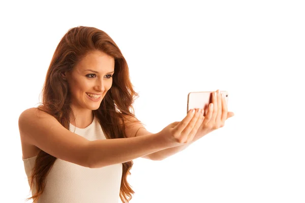 Woman making a selfie with a smart phone isolated over white — Stock Photo, Image