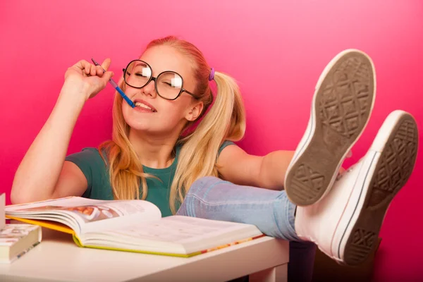 Playful schoolgirl with big eyeglasses concentrated thinking on — Stock Photo, Image