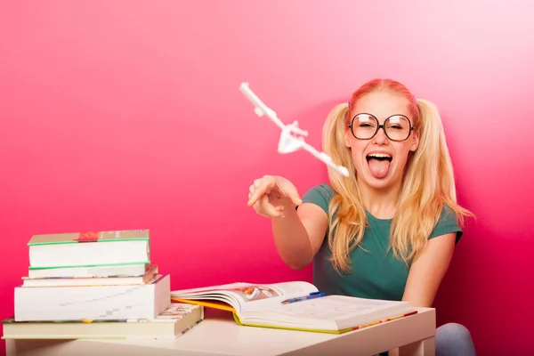 Playful, naughty schoolgirl with big eyeglasses playing with pap — Stock Photo, Image