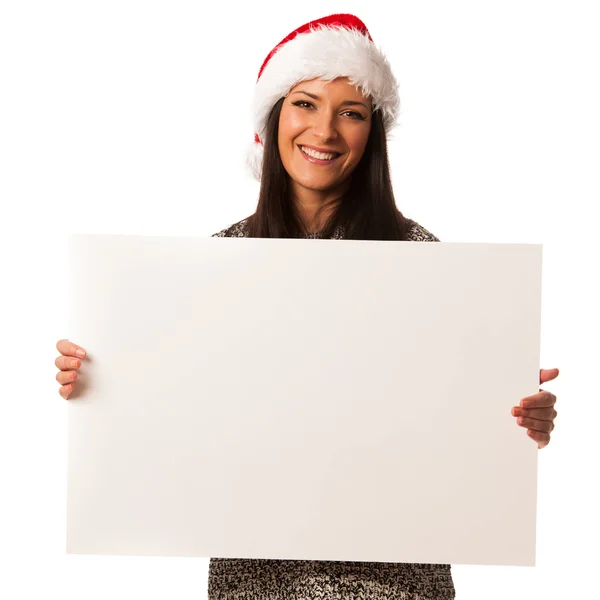 Young woman in santa hat holding blank board for advertisement. — Stock Photo, Image