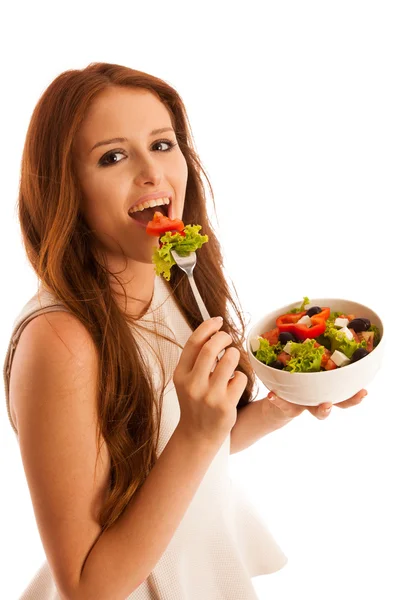 Healthy eating  - woman eats a bowl of greek salad isolated over — Stock Photo, Image