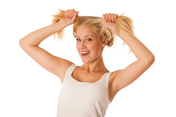 Beautiful young blonde woman holds hair in her hand gesturing ex — Stock Photo, Image