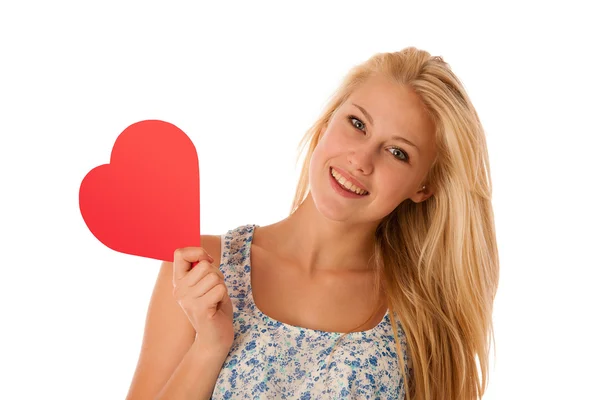 Beautiful young blonde woman with blue eyes holding red hart ban — Stock Photo, Image