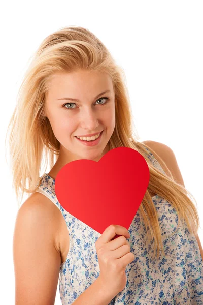 Beautiful young blonde woman with blue eyes holding red hart ban — Stock Photo, Image