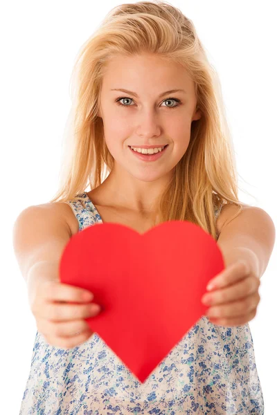 Beautiful young blonde woman with blue eyes holding red hart ban — Stock Photo, Image