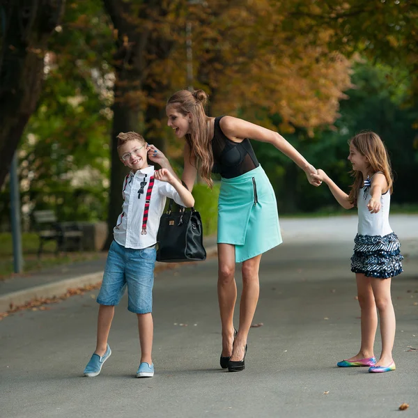 Mother with naughti son adn daughter on a walk in park — Stock Photo, Image