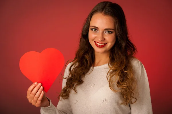 Attractive asian caucasian woman holding red heart in her hands — Stock Photo, Image