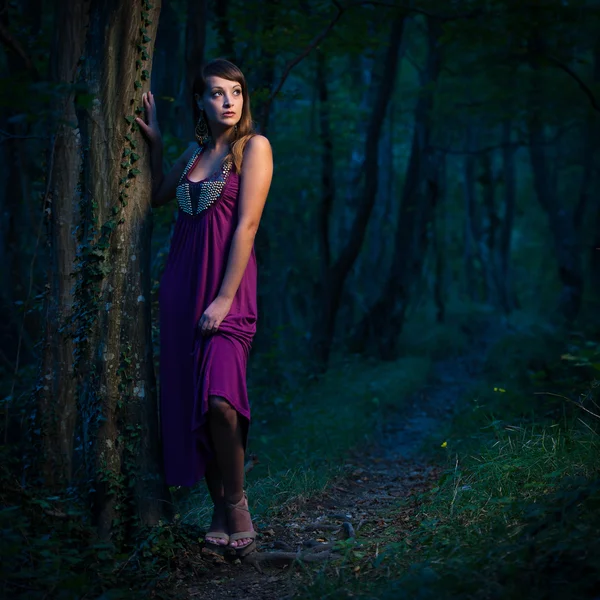 Frightened Beautiful lady on a forest path at dusk — Stock Photo, Image