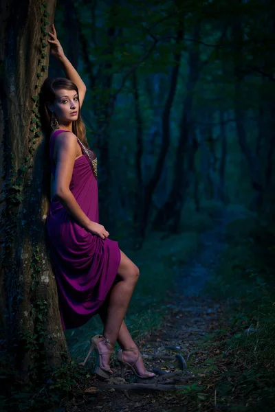 Frightened Beautiful lady on a forest path at dusk — Stock Photo, Image