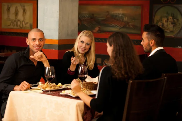 Young people eat sea food dinner at restaurant and drink wine — Stock Photo, Image