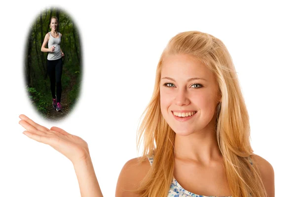 Happy blonde caucasian woman holds hand in copyspace isolated over white with a bauble image of a runner outdoors running in forest — Stock Photo, Image