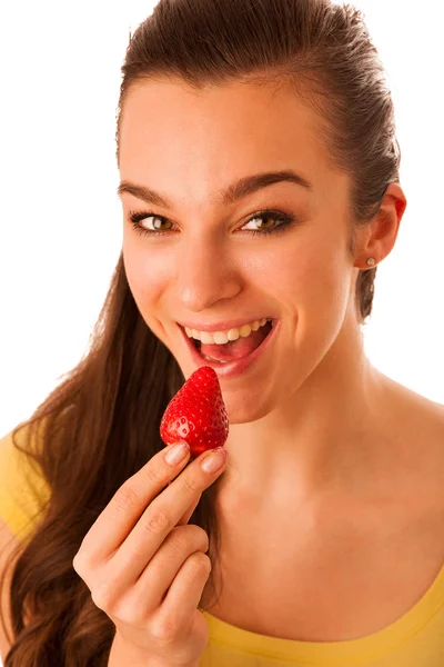 Beautiful happy asian caucasian woman in yellow t shirt eating s — Stock Photo, Image