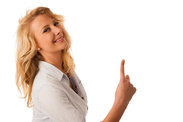 Young woman pointing into copy space isolated over white backgr — Stock Photo, Image