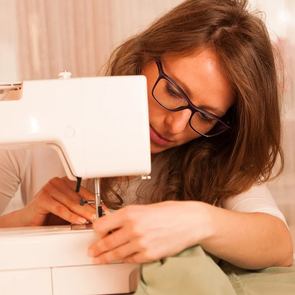 Vestidor mulher trabalhando com máquina de costura — Fotografia de Stock