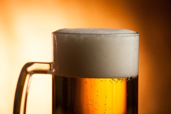 Big glass with handle filled with fresh beer with a lot of foam — Stock Photo, Image