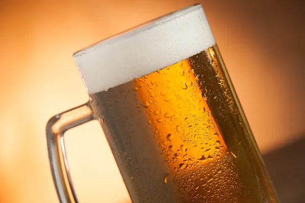 Big glass with handle filled with fresh beer with a lot of foam — Stock Photo, Image