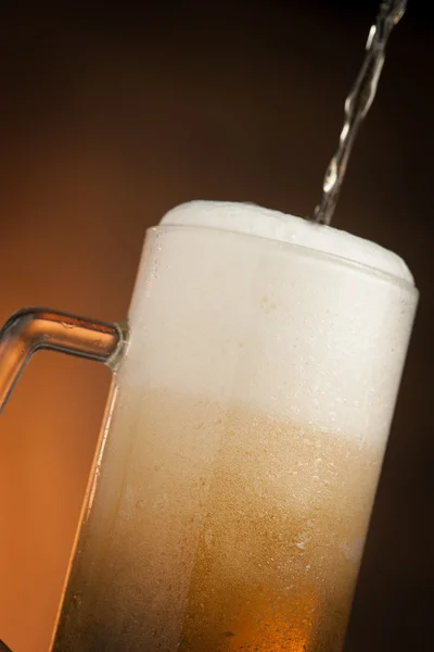 Big glass with handle filled with fresh beer with a lot of foam — Stock Photo, Image