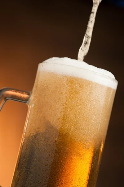 Big glass with handle filled with fresh beer with a lot of foam — Stock Photo, Image