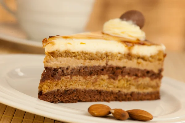 Deliceous slice og Caramel Mousse cake on a plate  closeup photo — Stock Photo, Image