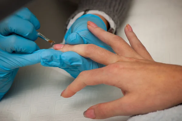 Making hand nails in a professional hand care salon - manicure — Stock Photo, Image