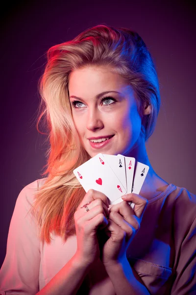 Beautiful caucasian woman with poker cards gambling in casino with four aces in hands — Stock Photo, Image