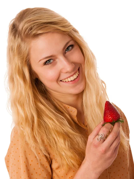 Beautiful blond cheerful caucasian woman eats a big red strawber — Stock Photo, Image