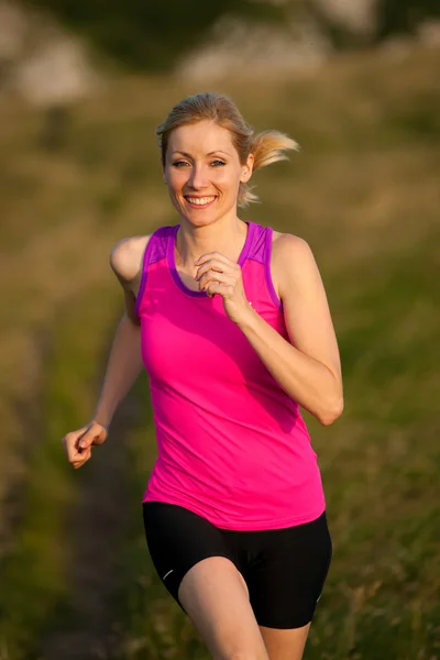 Vacker ung kvinna runns terränglöpning på en mountian bana på — Stockfoto