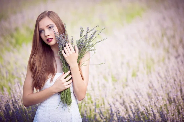 Beautiful young woman on lavender field — Stock Photo, Image
