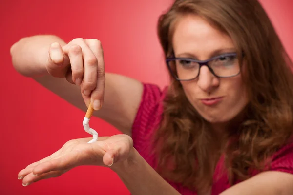 Beautiful young woman breaks a cigarette as a gesture for quit s — Stock Photo, Image