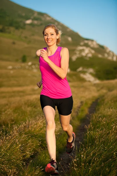 Mooie jonge vrouw runns Langlaufbericht padtekst Mountain op — Stockfoto