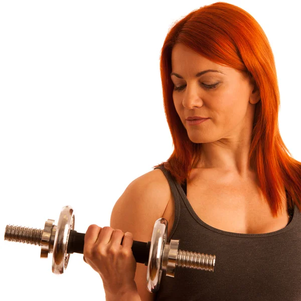 Beautiful young woman working out with dumbels in fitness gym — Stock Photo, Image