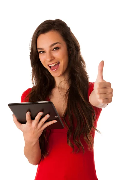 Beautiful young business woman looking at tablet gesturing succe — Stock Photo, Image