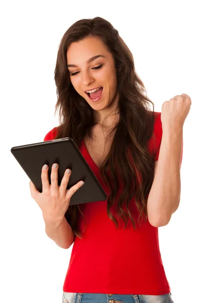 Beautiful young business woman looking at tablet gesturing succe — Stock Photo, Image