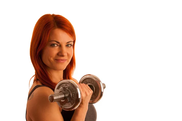 Beautiful young woman working out with dumbels in fitness gym — Stock Photo, Image