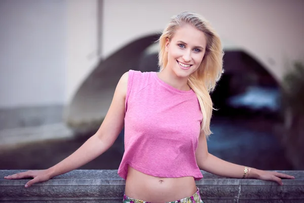 Beautiful young blonde woman on a walk arownd the city near to the castle in summer sunny day — Stock Photo, Image