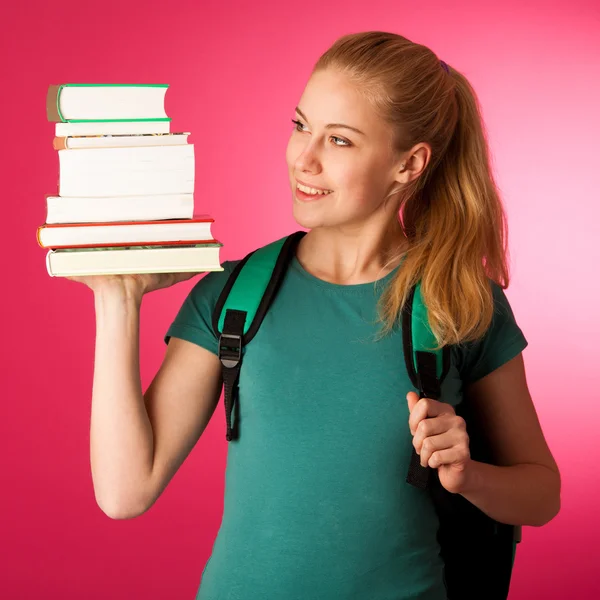 Studente bionda con pila di libri e zaino, felice di ottenere kn — Foto Stock