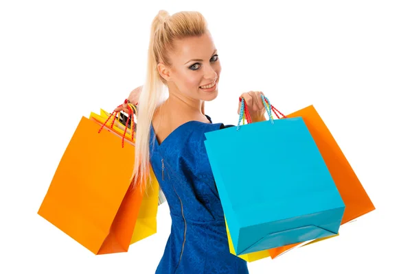Happy blonde woman holding bunch of vibrant shopping bags after Royalty Free Stock Images