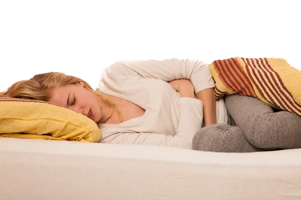 Woman lying in bed holding belly because of the pain in stomac. — Stock Photo, Image