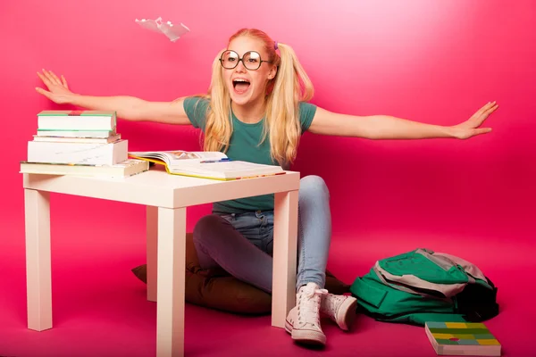 Playful, naughty schoolgirl with big eyeglasses playing with pap — Stock Photo, Image