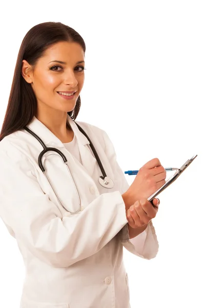 Woman doctor with stethoscope around neck writing diagnose on cl Stock Picture