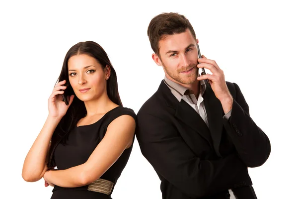 Business couple standing together and talking over phone, leanin — Stock Photo, Image