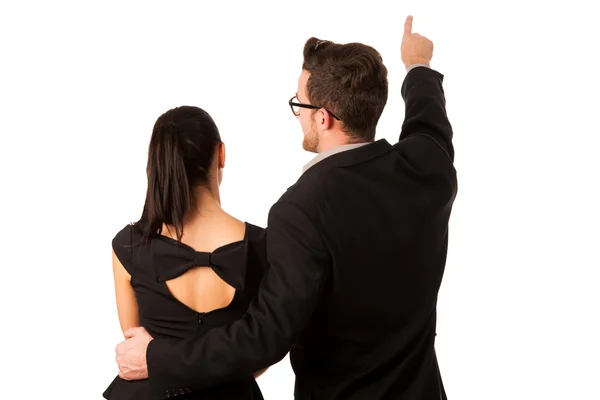 Confident business couple standing next to each other, pointing — Stock Photo, Image