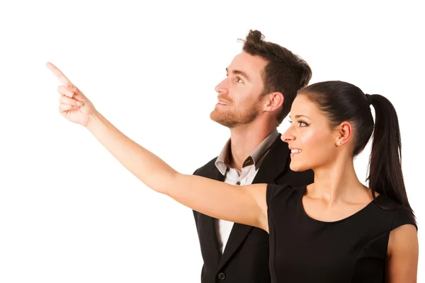 Confident business couple standing next to each other, pointing — Stock Photo, Image