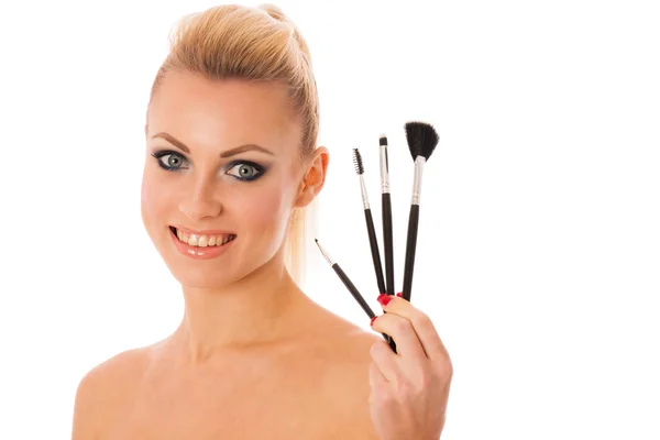 Portrait of woman holding beauty accessories, mascara, pauder br — Stock Photo, Image