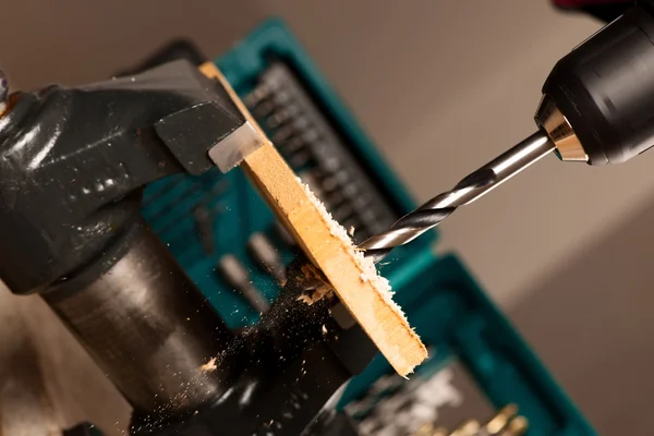 Image of drilling hole in wood clamped in vice tool. — Stock Photo, Image