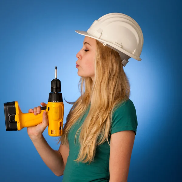 Frau mit Bauhelm und Werkzeug freut sich über harte Arbeit. — Stockfoto