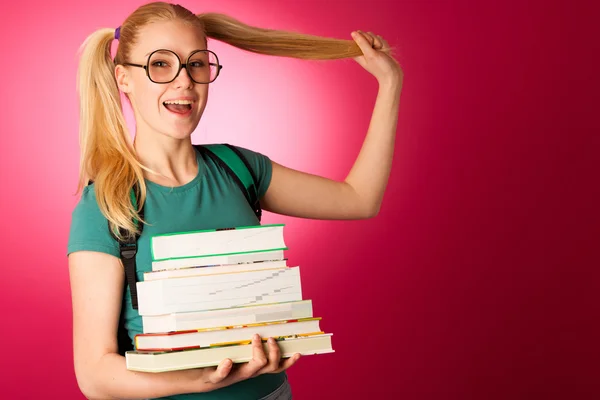 Curious, naughty, playful schoolgirl with stack of books and big — Stock Photo, Image