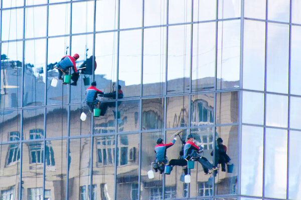 Moscow, Russia, September 15, 2020. A group of workers washes the windows of a skyscraper