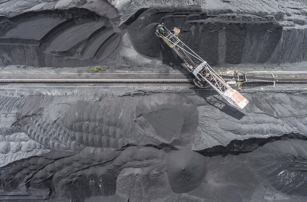 Mining excavator on the bottom surface mine. Brown coal deposits