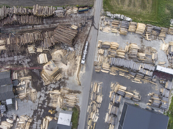 Sawmill. Felled trees, logs stacked in a pile. View from above. 